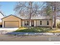 Charming single-story home featuring a well-manicured front lawn and a two-car attached garage at 1420 Fillmore Pl, Louisville, CO 80027