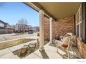 Inviting covered front porch with stone details, ideal for relaxing and enjoying the neighborhood view at 1526 Chukar Dr, Longmont, CO 80504