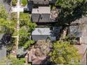 An aerial view of a house with a gray roof, surrounded by mature trees at 3056 W 34Th Ave, Denver, CO 80211