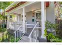 Lovely front porch with white columns and railing, and a decorative security door and a porch swing at 3056 W 34Th Ave, Denver, CO 80211