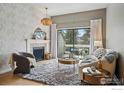Cozy living room with fireplace, plush rug, stylish furniture and a sliding glass door to a balcony with mountain views at 3260 47Th St # 206A, Boulder, CO 80301