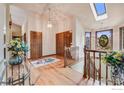 Bright foyer with beautiful wood flooring, skylight and decorative light fixtures at 5665 Cascade Pl, Boulder, CO 80303
