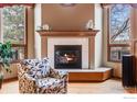 Cozy living room featuring a fireplace with tile surround and large windows at 5665 Cascade Pl, Boulder, CO 80303