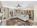 Spacious living room seamlessly flows into the kitchen, offering a comfortable seating area and modern design at 6280 Snowberry Ave, Firestone, CO 80504