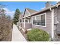 Charming home featuring neutral siding, well-maintained landscaping, and a welcoming entrance with bright, natural light at 6826 W 84Th Cir # 14, Arvada, CO 80003