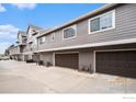 Spacious garages in a well-maintained building, each equipped with individual doors and ample parking space outside at 6826 W 84Th Cir # 14, Arvada, CO 80003