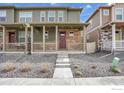 Charming home featuring a covered front porch and stone facade for added curb appeal at 7017 Kali Ct, Frederick, CO 80530