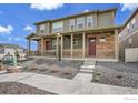 Street view of charming home with covered front porch and low maintenance landscaping at 7017 Kali Ct, Frederick, CO 80530