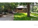 Charming home with a well-maintained lawn, mature trees, and a welcoming front porch at 747 12Th St, Boulder, CO 80302