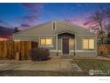 Charming single story home featuring a tidy landscaped front yard with walkway and distinctive purple front door at 7974 Chase Cir # 77, Arvada, CO 80003