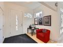 Bright foyer featuring modern decor, a red accent chair, and minimalist design elements at 955 Jasmine Cir, Boulder, CO 80304