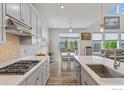 Kitchen features gray cabinets, stainless steel appliances, quartz countertops with an eat-in dining area at 1863 Pioneer Cir, Lafayette, CO 80026