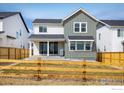 Charming home backyard with a well-maintained lawn, framed by a rustic wooden fence at 16568 W 92Nd Pl, Arvada, CO 80007