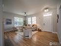 Spacious living room featuring hardwood floors, abundant natural light and neutral tones at 2946 Shoshone Trl, Lafayette, CO 80026