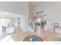 Open-concept home featuring hardwood floors, a staircase, and access to several rooms at 360 Peregrine Cir, Broomfield, CO 80020