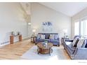 A stylish living room with modern sofas, hardwood floors, and large windows at 360 Peregrine Cir, Broomfield, CO 80020