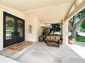 Inviting front porch with decorative double doors and charming outdoor seating at 7155 Rustic Trl, Boulder, CO 80301