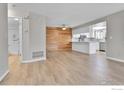 Open living space with wood floors, updated kitchen, and modern design accents at 9501 W 89Th Cir, Broomfield, CO 80021
