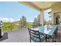 Spacious back deck with a table and seating, perfect for outdoor dining and overlooking a scenic view at 10113 Thunder Run, Littleton, CO 80125