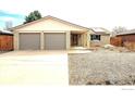 Charming single-story home featuring a two-car garage, brick facade, and well-maintained yard at 1410 Oak Dr, Berthoud, CO 80513