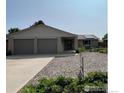 Charming single-story home with a two-car garage and a well-maintained front yard at 1410 Oak Dr, Berthoud, CO 80513