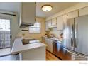 Well-lit kitchen with stainless steel appliances and ample countertop space, great for cooking at 1865 Terry St # 3, Longmont, CO 80501