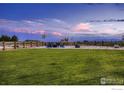 Spacious backyard featuring a fire pit with mountain views and wooden fence at 38 Morgan S Cir, Erie, CO 80516
