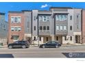 Modern townhomes with mixed brick and gray siding create appealing curb appeal on this street at 417 Promenade Dr, Superior, CO 80027