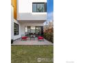Backyard with a grassy lawn, patio with outdoor seating, and modern design at 2304 Pearl St # 2, Boulder, CO 80302