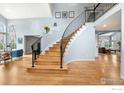 Grand two-story foyer with hardwood floors, elegant staircase, and abundant natural light at 2345 Spotswood Pl, Boulder, CO 80304