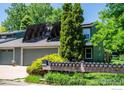 Charming two-story home features solar panels, an attached garage, and manicured landscaping at 4248 Corriente Pl, Boulder, CO 80301