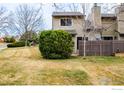 Exterior view of a well-maintained home with a green lawn and mature trees at 4248 Corriente Pl, Boulder, CO 80301