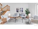Bright living room boasts a gray sofa, neutral armchairs, and stylish décor accents at 4248 Corriente Pl, Boulder, CO 80301