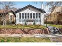 Charming home with neat lawn, brick wall, and freshly painted exterior at 1282 S Sherman St, Denver, CO 80210