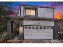 Charming home exterior showcasing a two-car garage and inviting front porch at dusk at 4808 Hopkins Pl, Boulder, CO 80301