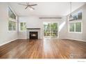 Spacious living room with fireplace, hardwood floors, and large windows offering ample natural light at 4808 Hopkins Pl, Boulder, CO 80301