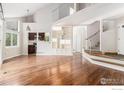 Bright living room features hardwood floors, an open layout, and easy access to the kitchen and upper level at 4808 Hopkins Pl, Boulder, CO 80301