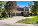 Charming two-story home with a well-manicured lawn, mature trees, and two car garage at 6850 Frying Pan Rd, Boulder, CO 80301