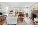 Bright and airy living room with hardwood floors, fireplace, and plenty of natural light at 6850 Frying Pan Rd, Boulder, CO 80301