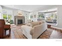 Cozy living room featuring a fireplace, hardwood floors, and ample natural light at 6850 Frying Pan Rd, Boulder, CO 80301