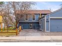 Shot of a two-story home with garage plus a fenced back patio at 1095 Tantra Park Cir, Boulder, CO 80305
