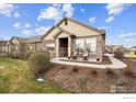 Beautiful home with stone and siding, a charming front porch with chairs, and attractive landscaping at 12564 Madison Way, Thornton, CO 80241