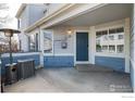 Inviting front porch featuring a sleek heating unit and ample space for outdoor enjoyment at 1419 Red Mountain Dr # 15, Longmont, CO 80504