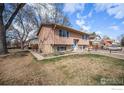 View of a two-story home showcasing the surrounding landscaping and blue sky at 1529 Ashcroft Dr, Longmont, CO 80501