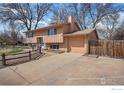 Charming two-story home with a manicured lawn, fenced yard, and attached garage at 1529 Ashcroft Dr, Longmont, CO 80501