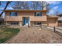 Charming two-story home featuring a well-maintained front yard and inviting blue front door at 1529 Ashcroft Dr, Longmont, CO 80501