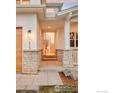 Welcoming home entrance featuring stone accents and a glimpse of the interior staircase at 1575 Kalmia Ave, Boulder, CO 80304