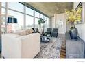 Comfortable living room showcasing city views from large windows, a plush sofa and contemporary accents at 1700 Bassett St # 1013, Denver, CO 80202
