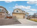 Well-maintained two-story home with a two-car garage, complemented by attractive landscaping at 17995 E 107Th Pl, Commerce City, CO 80022