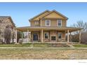 Charming two-story home featuring a spacious covered porch and stone fireplace at 2339 Whistler Dr, Longmont, CO 80504